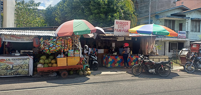A carinderia that sells home cooked meals and snack cart