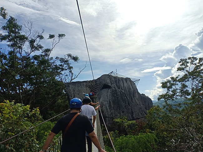 A sturdy suspended bridge to reach the top of a rock hill in Masungi Georeserve